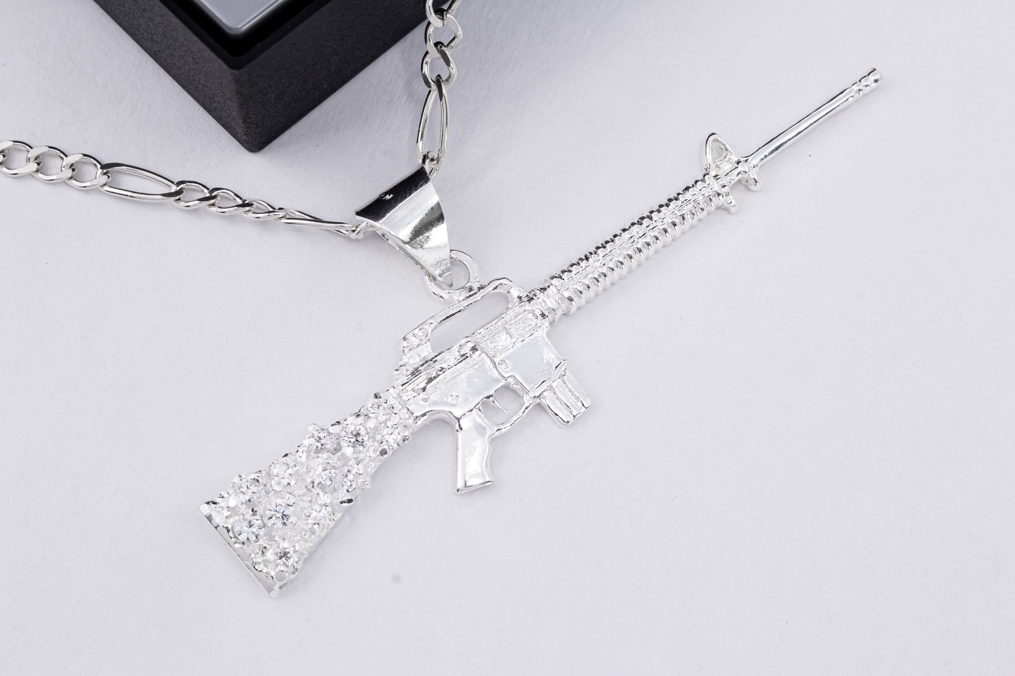 Dije Arma Larga Zirconias Blancas